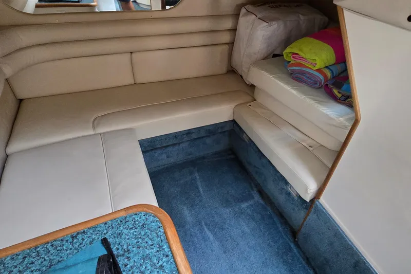 Slide: The Image of Interior of 1995 Sea Ray 330 Sundancer with beige seating and blue carpet. - 29