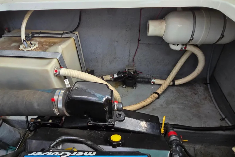 Slide: The Image of Engine compartment of a 1995 Sea Ray 330 Sundancer boat, showing hoses and components. - 39