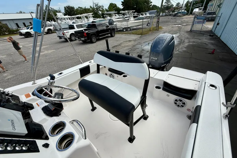 Slide: The Image of 2018 Robalo R180 Center Console boat with Yamaha 150 engine, parked in a marina. - 10