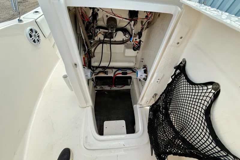 Slide: The Image of 2018 Robalo R180 Center Console boat interior wiring and storage compartment. - 12