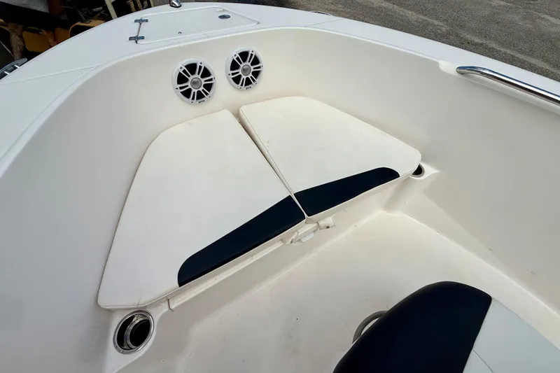 Slide: The Image of 2018 Robalo R180 Center Console boat interior with cushioned seating and speakers. - 13