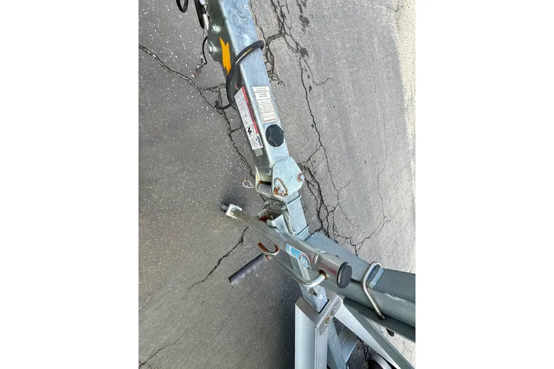 Slide: The Image of Trailer hitch of a 2018 Robalo R180 Center Console on cracked pavement. - 14