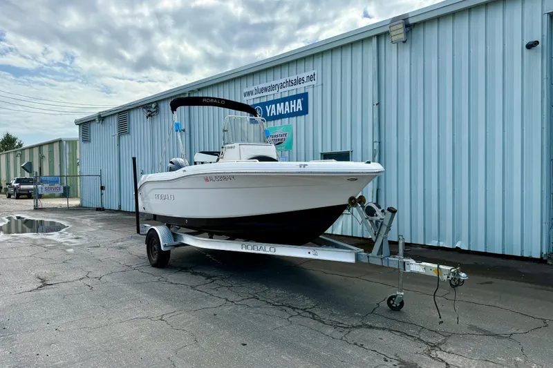 Slide: The Image of 2018 Robalo R180 Center Console boat on trailer outside dealership. - 3