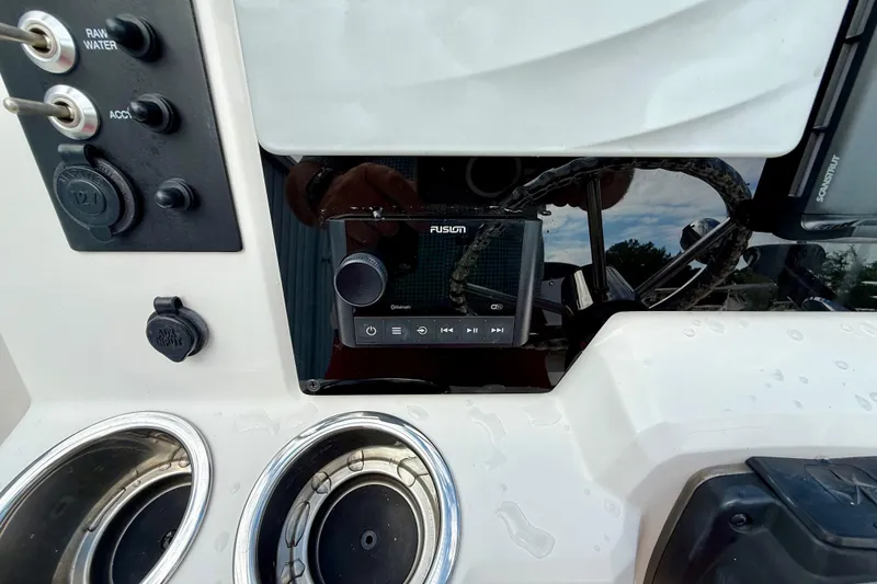 Slide: The Image of Control panel of 2018 Robalo R180 Center Console with Fusion audio system and cup holders. - 7