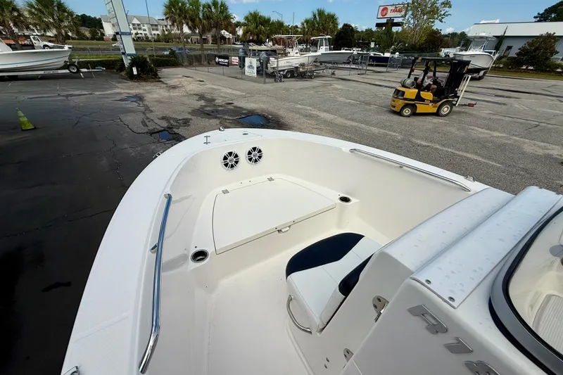 Slide: The Image of 2018 Robalo R180 Center Console boat in a marina with forklift in background. - 8