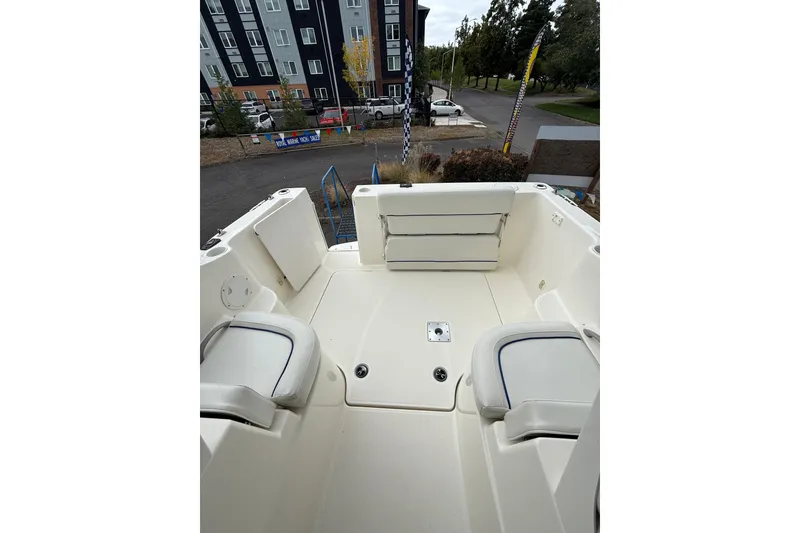 Slide: The Image of 2007 Bayliner 246 Discovery boat interior with seating and storage compartments. - 11