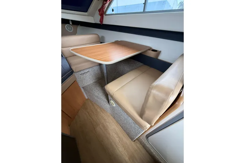 Slide: The Image of 2007 Bayliner 246 Discovery interior with dining area and seating. - 17