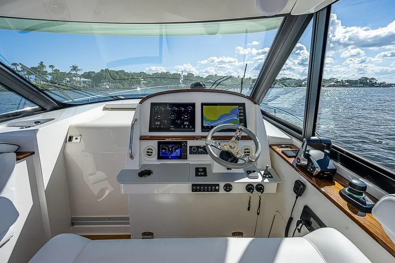 Slide: The Image of Helm of 2023 Hinckley 40x yacht with modern navigation equipment and scenic water view. - 16