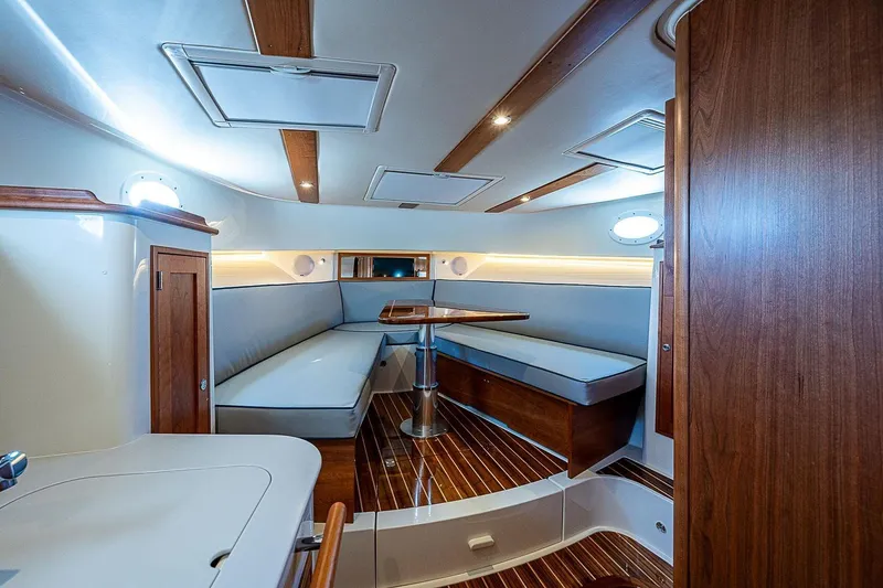 Slide: The Image of Luxurious interior of 2023 Hinckley 40x yacht with elegant wood finishes and seating area. - 18