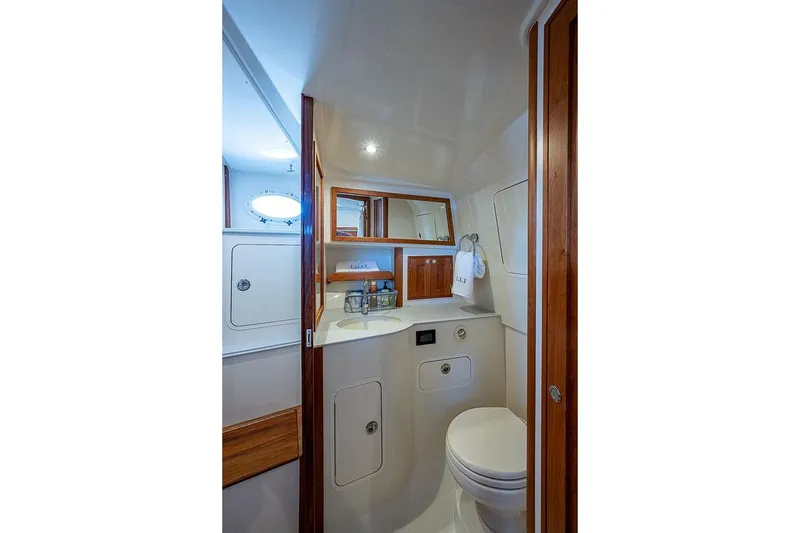 Slide: The Image of 2023 Hinckley 40x yacht bathroom with wooden accents and modern fixtures. - 19