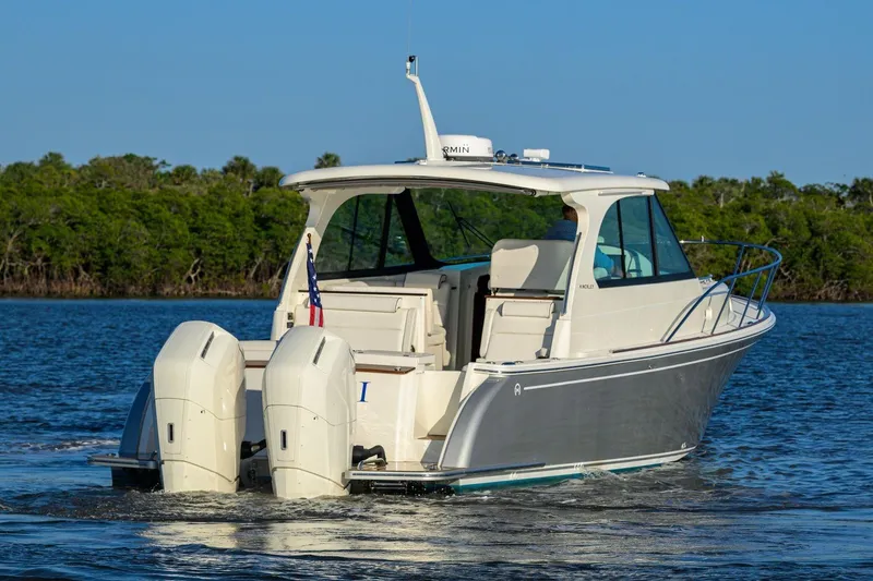Slide: The Image of 2023 Hinckley 40x boat cruising on water with dual outboard engines. - 4