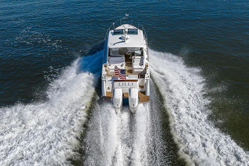 Slide: The Image of 2023 Hinckley 40x yacht cruising on open water, rear view with wake. - 7