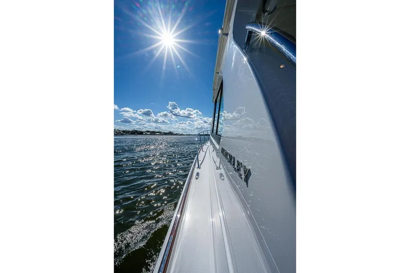 Slide: The Image of 2023 Hinckley 40x yacht cruising under bright sun on open water. - 8