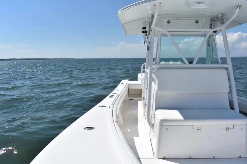 Slide: The Image of 2008 Regulator 32 Forward Seating boat on open water under clear blue sky. - 13