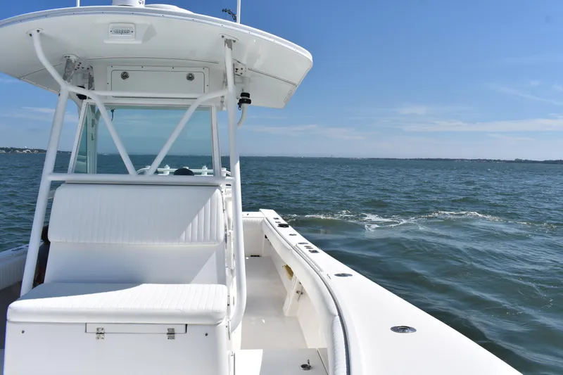 Slide: The Image of 2008 Regulator 32 Forward Seating boat on open water under clear blue sky. - 14