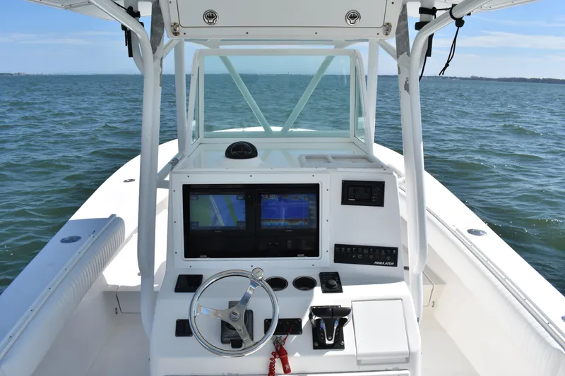 Slide: The Image of 2008 Regulator 32 Forward Seating boat dashboard with navigation screens on open water. - 17