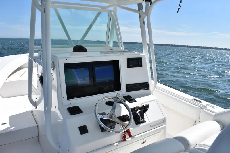 Slide: The Image of 2008 Regulator 32 Forward Seating boat dashboard with ocean view. - 19