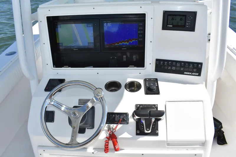 Slide: The Image of 2008 Regulator 32 Forward Seating boat dashboard with steering wheel and navigation displays. - 20