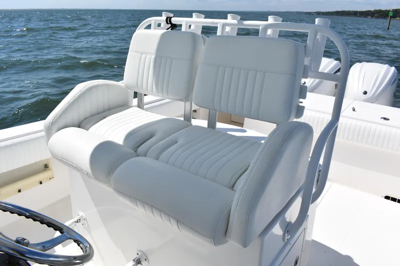 Slide: The Image of 2008 Regulator 32 Forward Seating boat with white cushioned seats on open water. - 22
