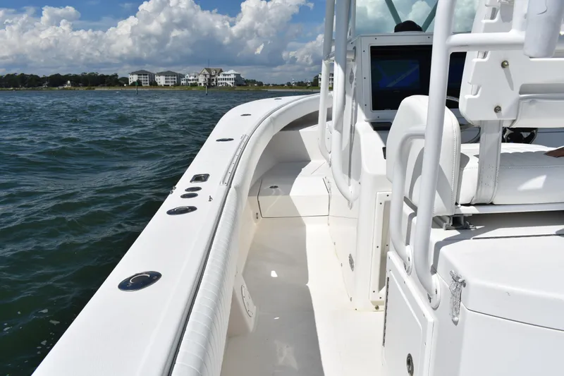 Slide: The Image of 2008 Regulator 32 Forward Seating boat on water, clear sky, coastal view. - 24