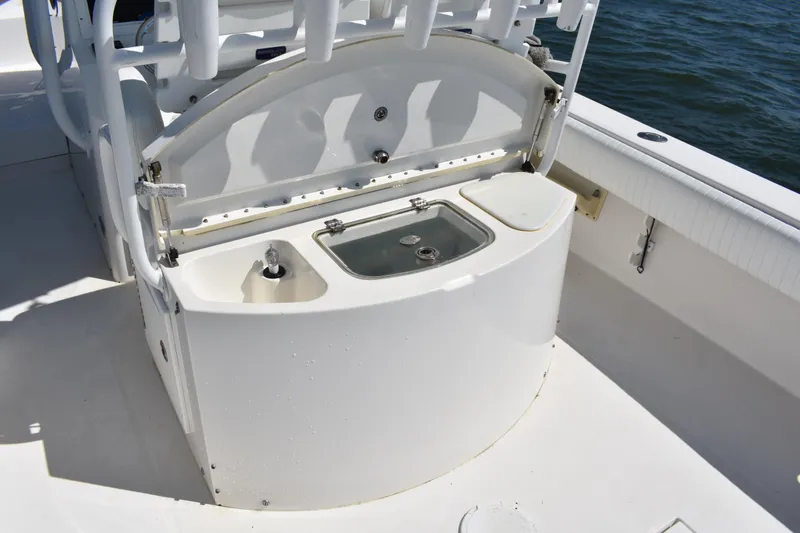 Slide: The Image of 2008 Regulator 32 Forward Seating boat interior with sink and storage area. - 28