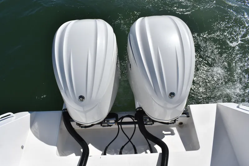 Slide: The Image of Twin outboard motors on a 2008 Regulator 32 Forward Seating boat in water. - 36