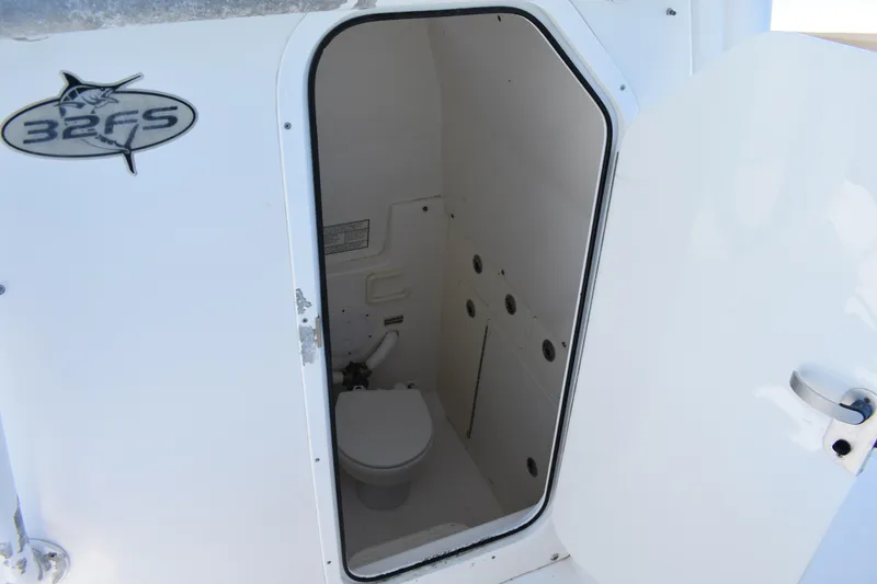 Slide: The Image of 2008 Regulator 32 Forward Seating boat interior with open door to compact restroom. - 38