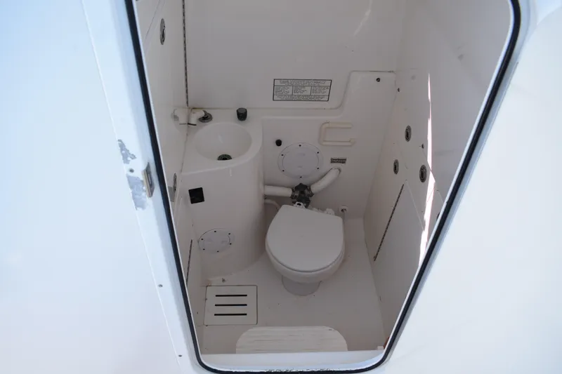 Slide: The Image of 2008 Regulator 32 Forward Seating boat interior with compact marine toilet and sink. - 39