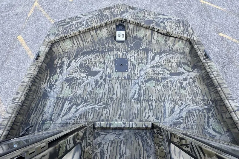 Slide: The Image of 2026 SeaArk 2272 MV FlatKat boat with camouflage pattern, viewed from above. - 10