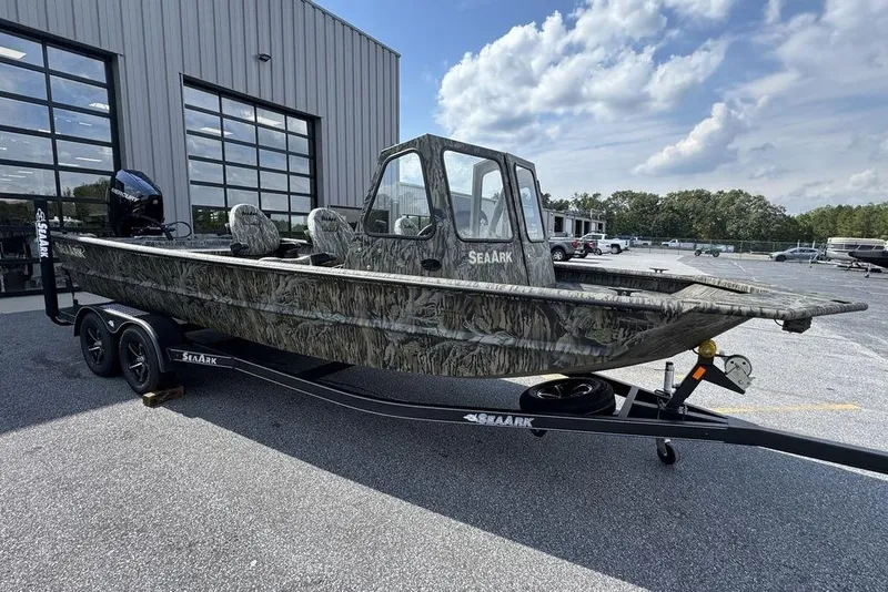 Slide: The Image of 2026 SeaArk 2272 MV FlatKat boat with camouflage design on a trailer. - 2