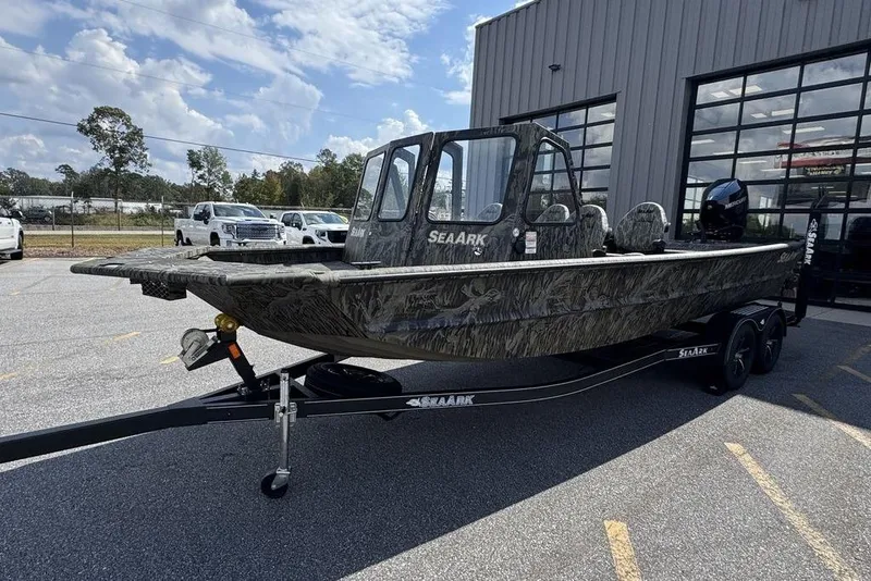 Slide: The Image of 2026 SeaArk 2272 MV FlatKat boat on trailer, camo design, parked outdoors. - 6