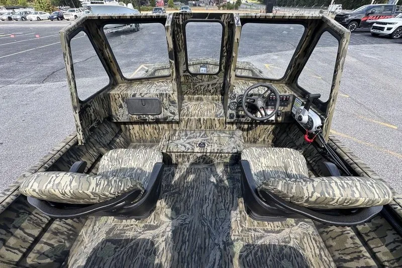 Slide: The Image of 2026 SeaArk 2272 MV FlatKat boat interior with camouflage design and dual seating. - 8