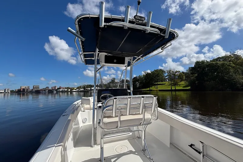 Slide: The Image of 2020 Seahunt 234 Ultra boat on calm water under a clear blue sky. - 7
