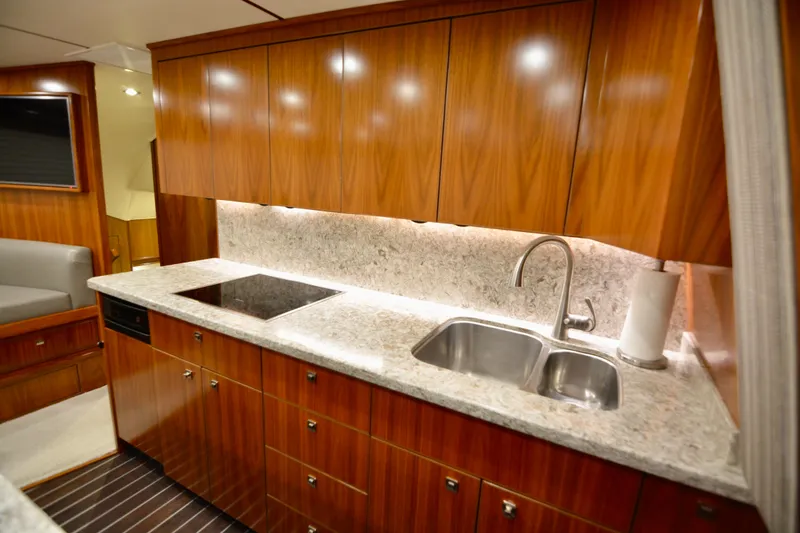 Slide: The Image of Luxurious kitchen interior of 2019 Viking 68 Convertible yacht with wood cabinetry and modern appliances. - 11