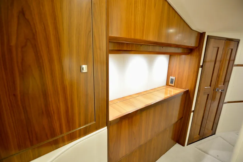 Slide: The Image of Luxurious wood interior of 2019 Viking 68 Convertible yacht, featuring elegant cabinetry and lighting. - 16