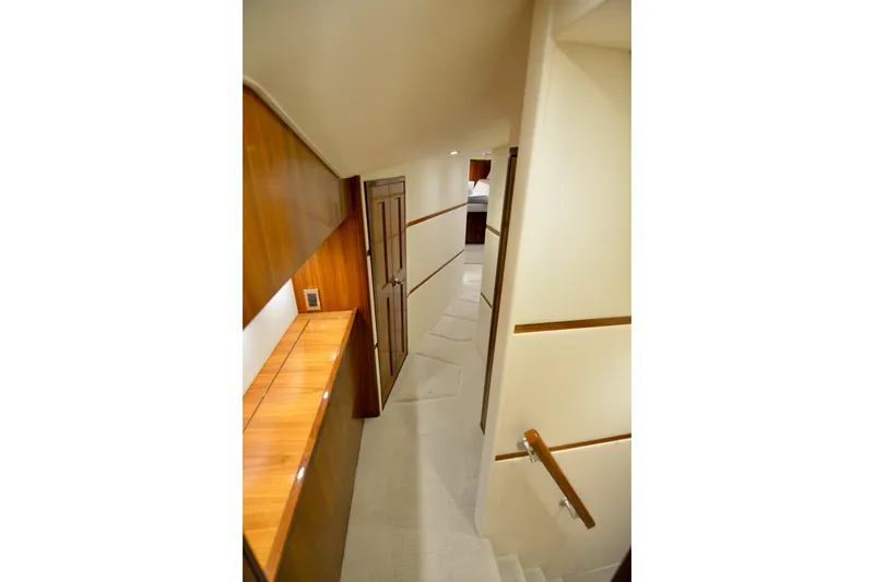 Slide: The Image of Interior hallway of 2019 Viking 68 Convertible yacht with wood accents and modern design. - 17