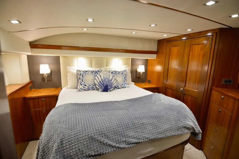 Slide: The Image of Luxurious bedroom interior of 2019 Viking 68 Convertible yacht with elegant wood finishes. - 19