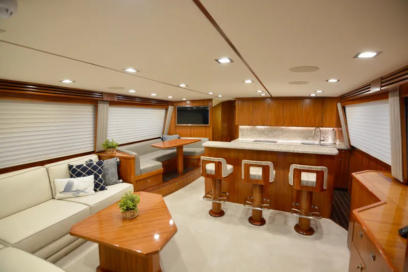 Slide: The Image of Luxurious interior of 2019 Viking 68 Convertible yacht with modern kitchen and seating area. - 2