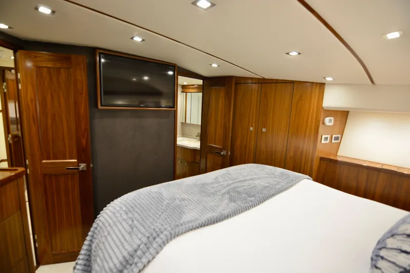Slide: The Image of Luxurious interior of 2019 Viking 68 Convertible yacht with wood paneling and modern amenities. - 20