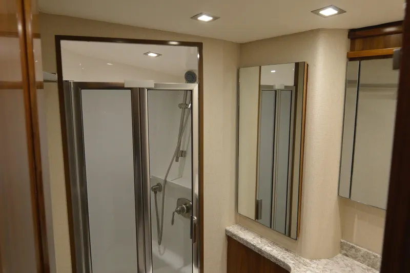 Slide: The Image of Luxurious bathroom interior of 2019 Viking 68 Convertible yacht with modern shower and mirrors. - 26