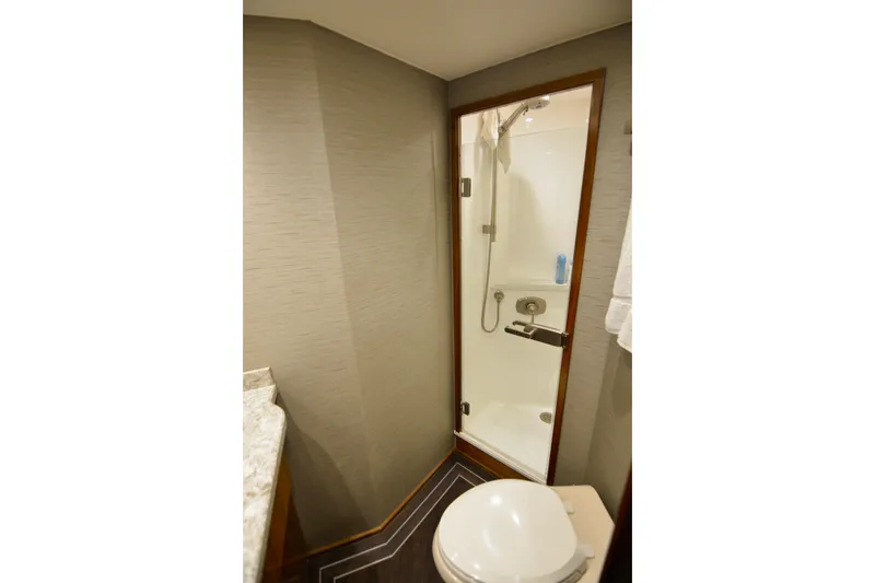 Slide: The Image of Bathroom interior of 2019 Viking 68 Convertible yacht with shower and toilet. - 30