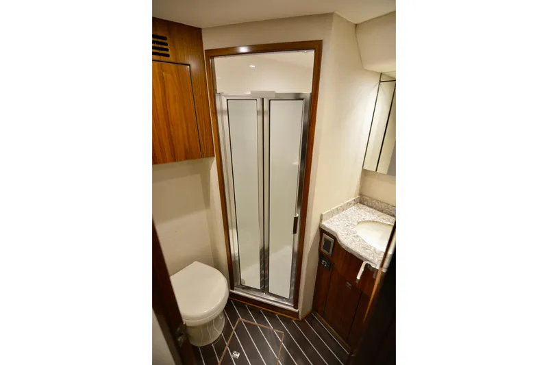Slide: The Image of Luxurious bathroom in 2019 Viking 68 Convertible yacht with shower and wooden accents. - 35