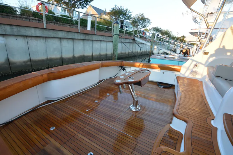 Slide: The Image of Luxurious 2019 Viking 68 Convertible yacht with polished wooden deck and seating area. - 39