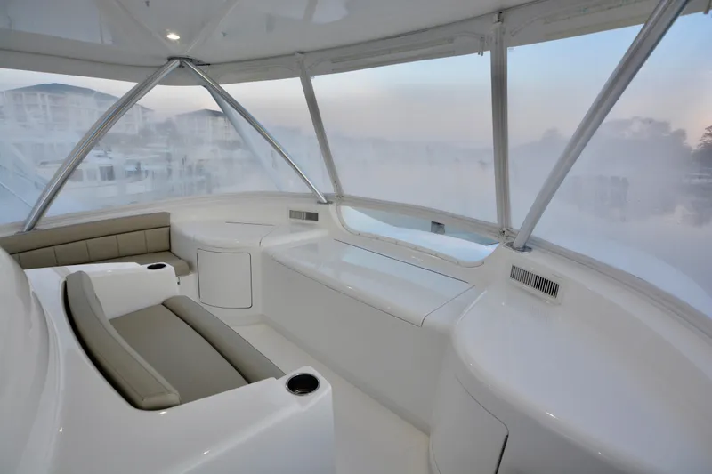 Slide: The Image of Luxurious interior of 2019 Viking 68 Convertible yacht with panoramic windows and seating. - 48