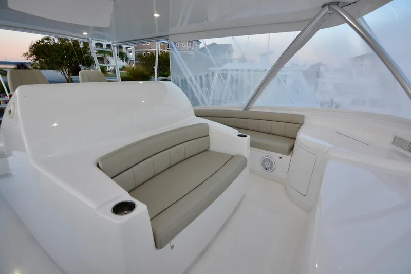 Slide: The Image of Luxurious seating area on a 2019 Viking 68 Convertible yacht, featuring sleek design and comfort. - 49