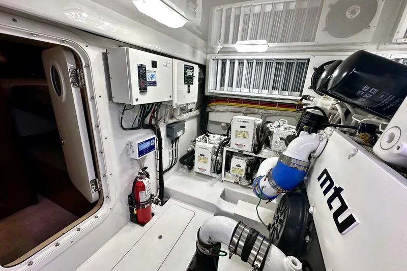 Slide: The Image of Engine room of 2019 Viking 68 Convertible yacht with MTU components and control panels. - 51