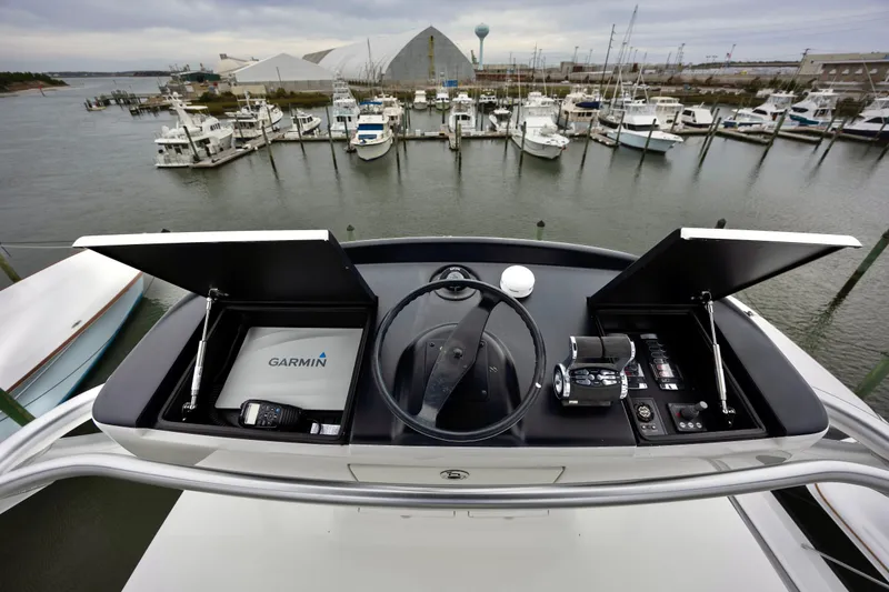 Slide: The Image of Cockpit view of 2019 Viking 68 Convertible yacht with Garmin navigation system. - 58