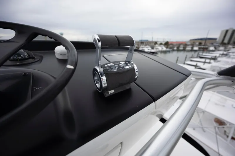 Slide: The Image of Control panel of 2019 Viking 68 Convertible yacht overlooking marina. - 59