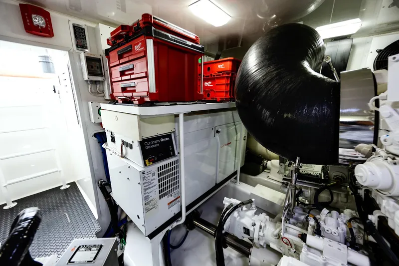 Slide: The Image of Engine room of 2019 Viking 68 Convertible yacht with Cummins Onan generator and toolboxes. - 62