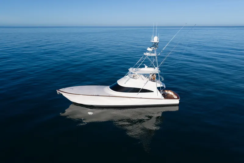 Slide: The Image of 2019 Viking 68 Convertible yacht on calm ocean waters. - 69